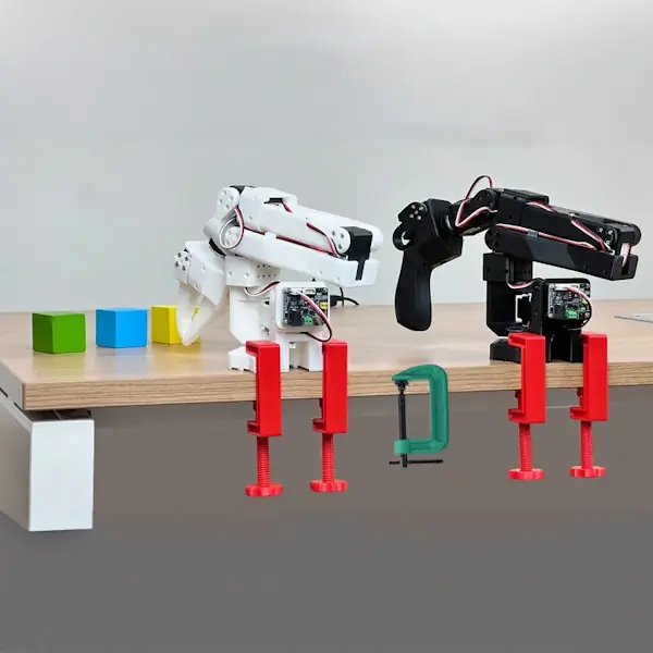 Two LeRobot arms in a lead and follow setup where one arm records motions and the second arm replicates them.